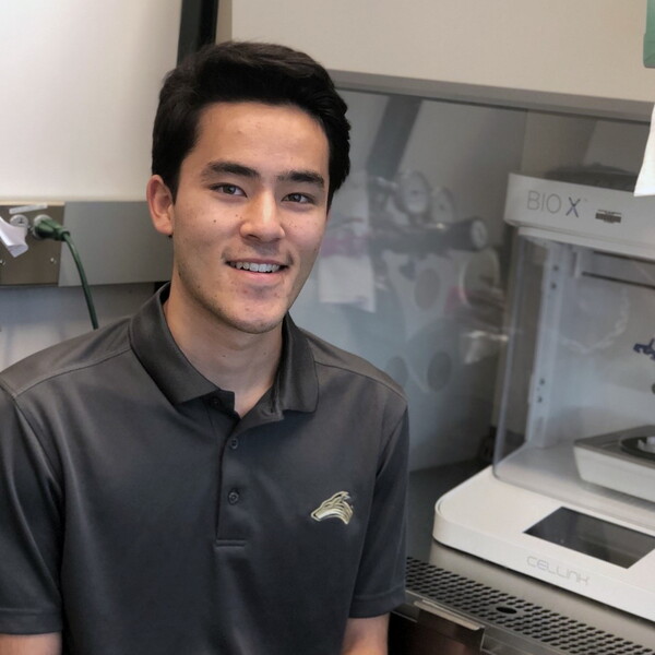 Anthony Baker, psychology student, in a lab doing research.