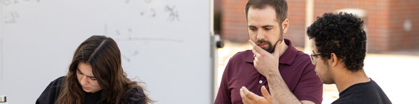 Math Professor Brent McKain teaches class outdoors with a rolling white board.