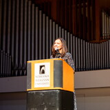 Carol Spahn, director of the US Peace Corps, gives remarks at podium.